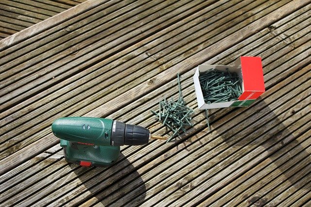 nail gun and nails on wooden deck